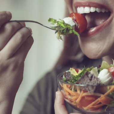 Femme méditant devant une assiette, symbole d’une alimentation consciente et apaisée.